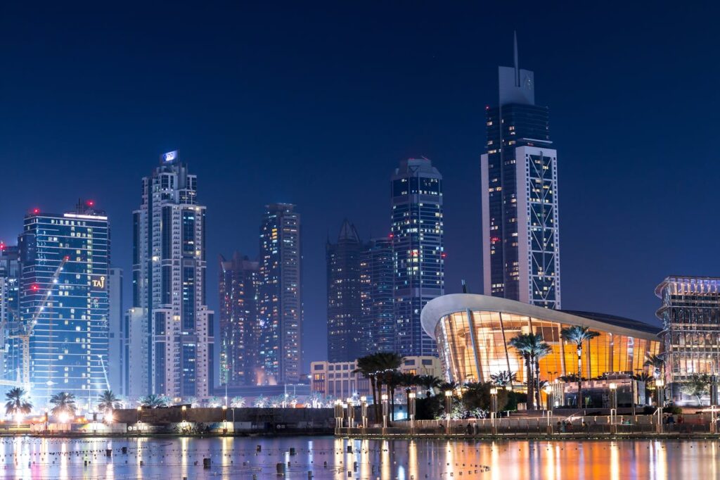pexels photo 442579 Stunning view of Dubai's illuminated skyline with modern skyscrapers reflecting on water at night.